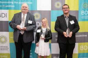 From left to right: Jim Lindquist, Lily D. Moore, and Jeremy Martinez with the Luminary Award
