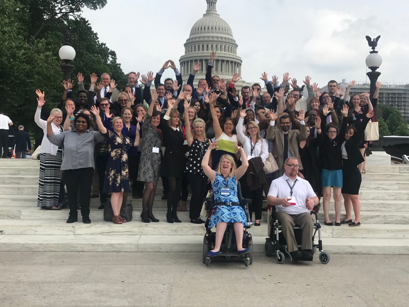 Kylie Moore in Washington, DC for the 2023 SourceAmerica conference with a group of other disability advocates in front of the Capitol.