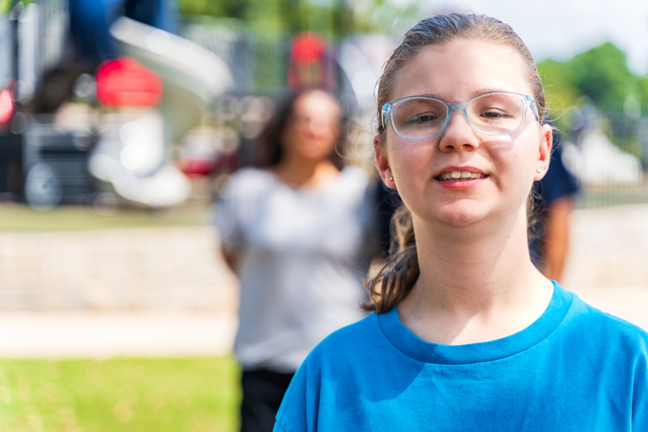 Annabella, a BDI service participant. In the background, he family is looking at her.