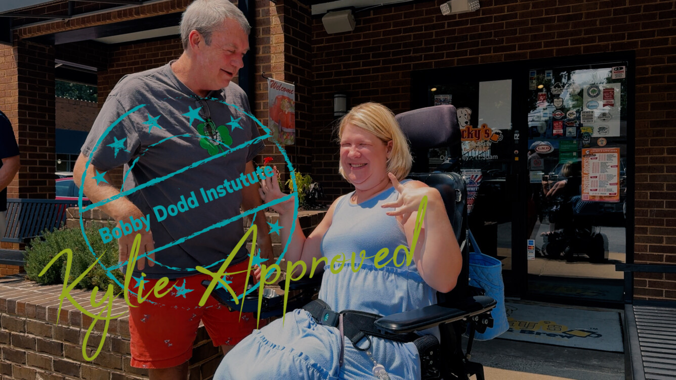 Kylie Moore with the owner of Lucky's Roswell during one of her accessibility adventures.