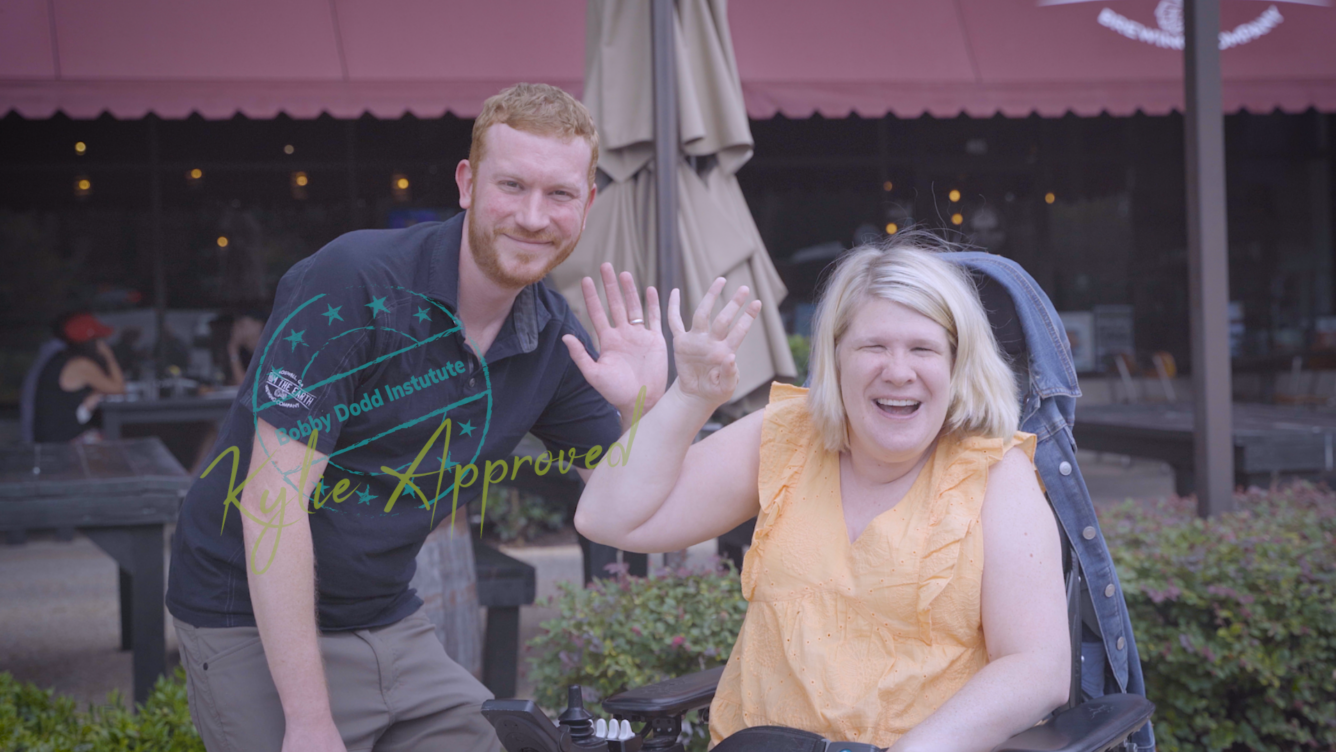 Kylie Moore, the author of Kylie's Accessibility Adventures, with the From the Earth Brewery general manager