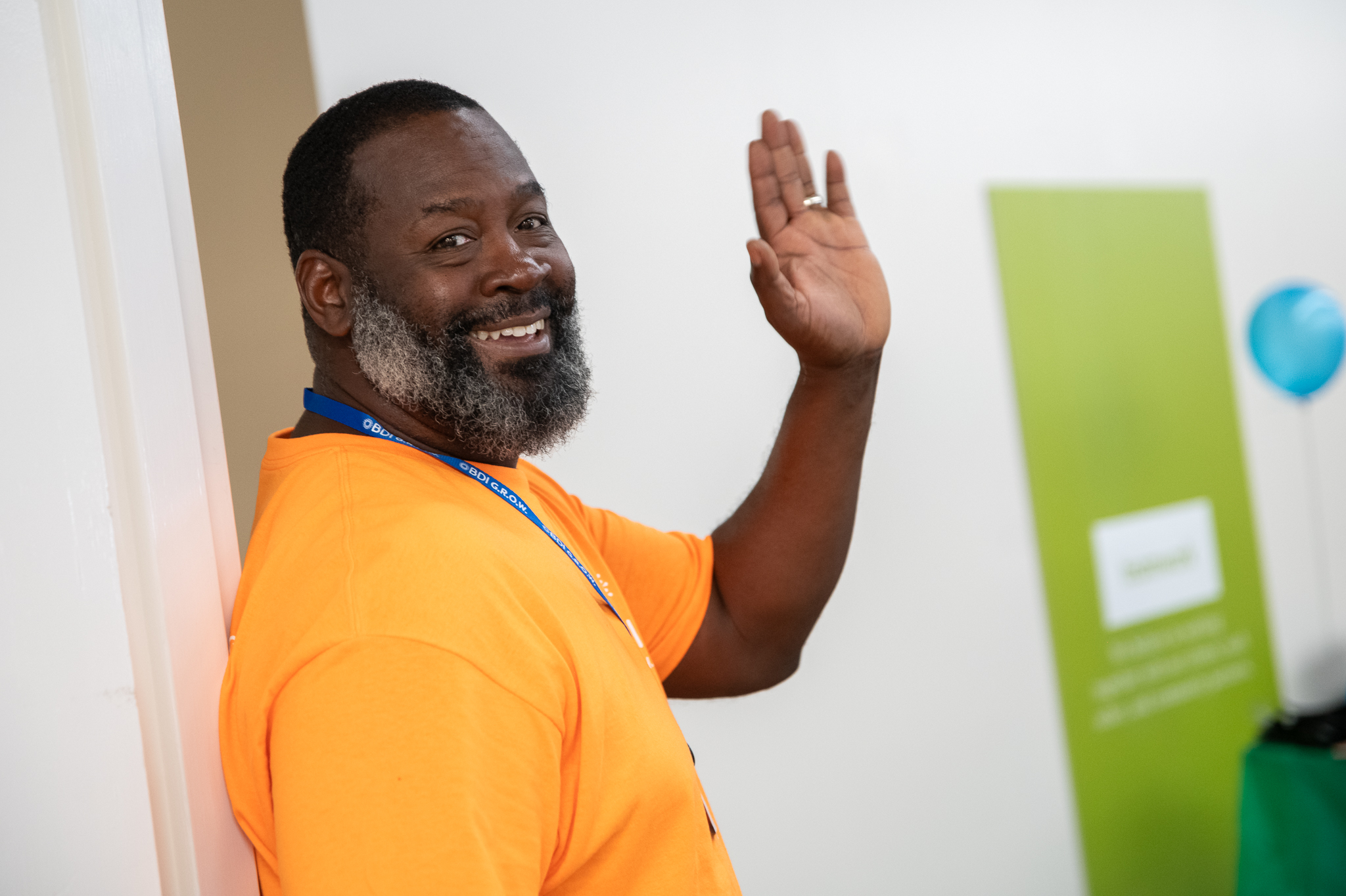 A BDI service participant waving and smiling