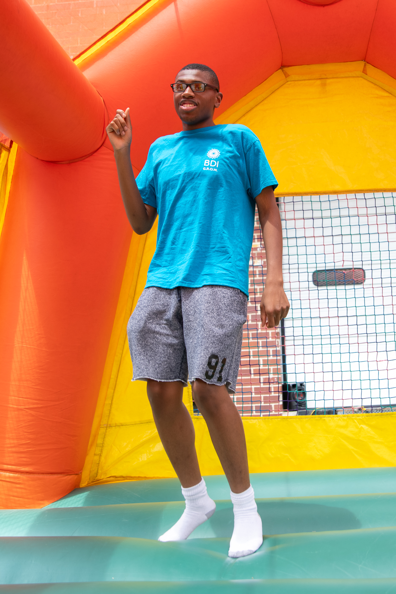 A BDI service participant having fun in a bouncy house during the 2023 GROW Summer Gathering.