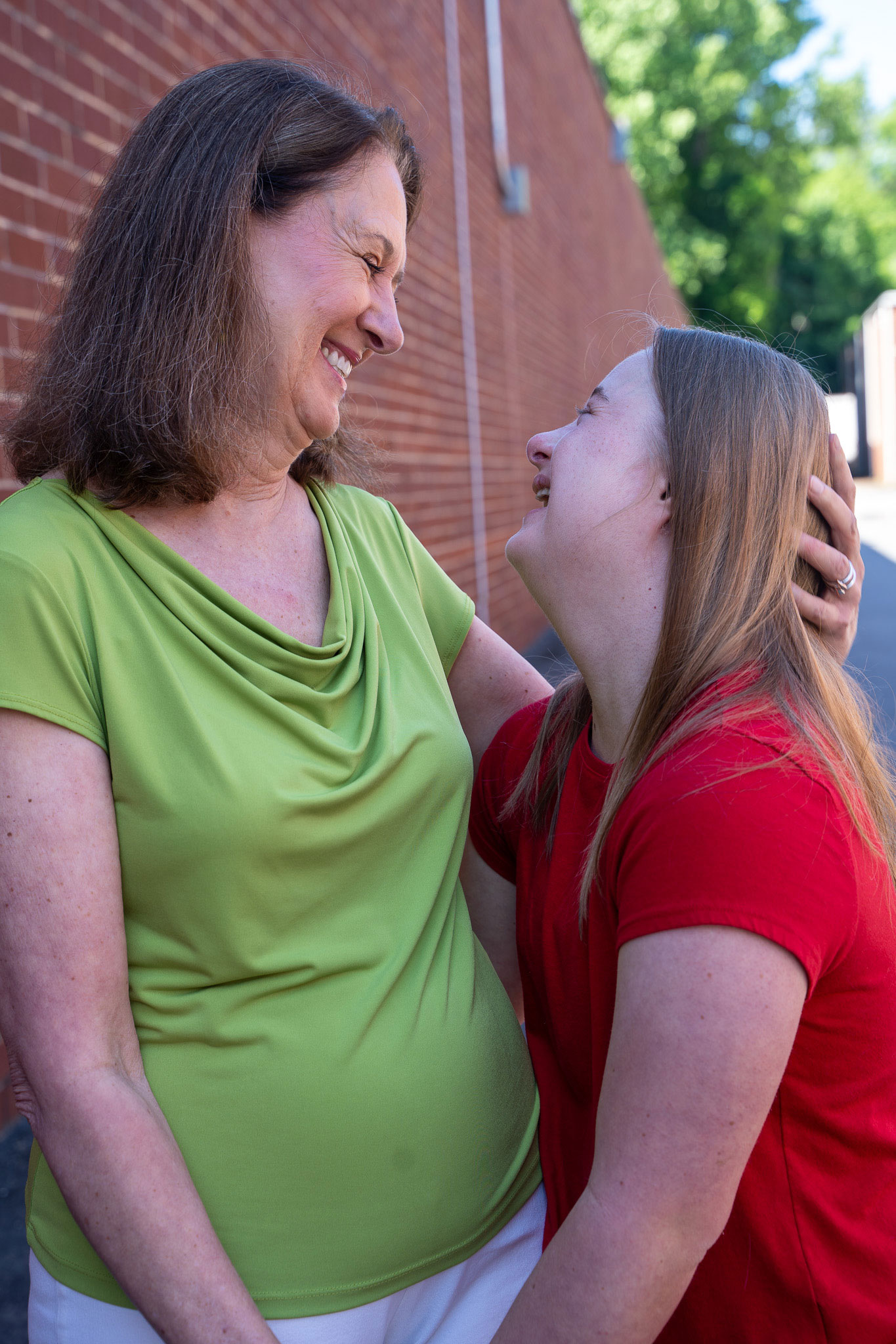 Avery, a BDI service participant, and her mom. Both looking at each others eyes and smiling.