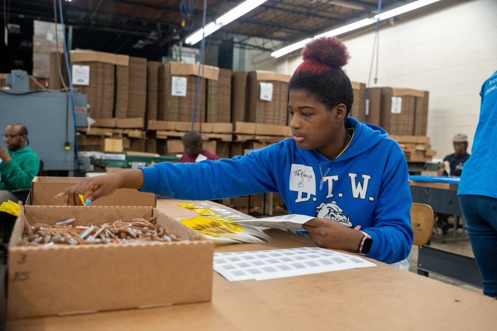 A BDI Pre-ETS participant is working in the Atlanta warehouse for one of our clients--Pure Flats.