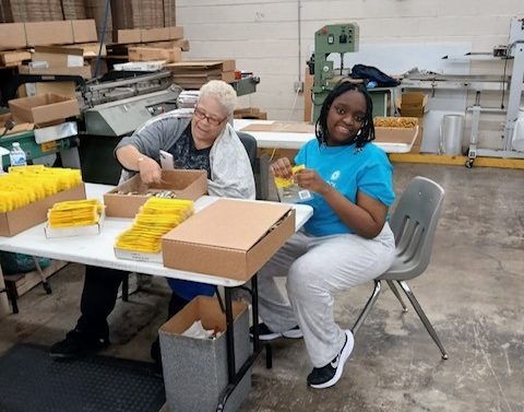 Crystal, a BDI service participant, working at the BDI warehouse as part of her one-week Pre-ETS camp