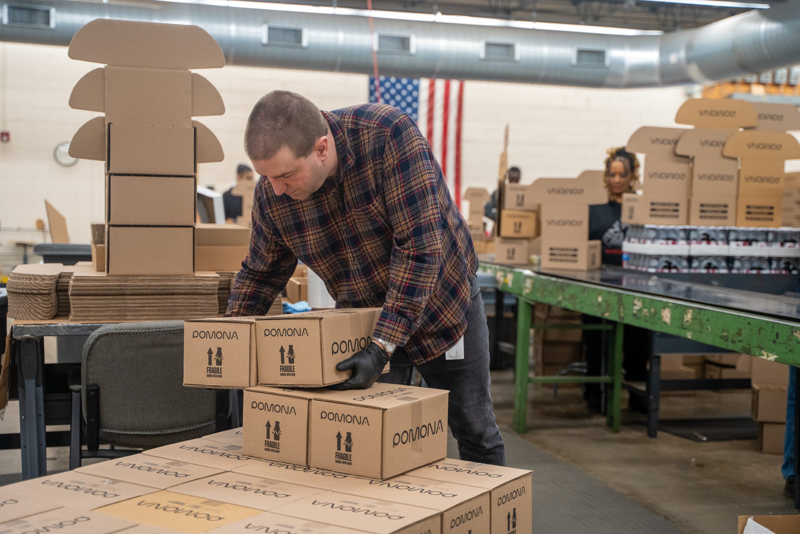 Production worker at the BDI warehouse stacking boxes.